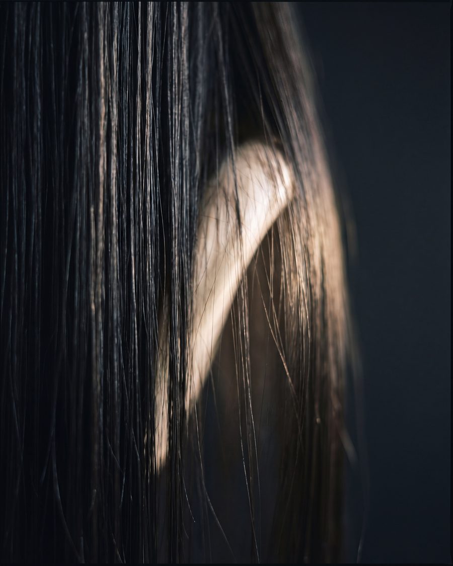 A close view of smooth, glossy straightened hair.